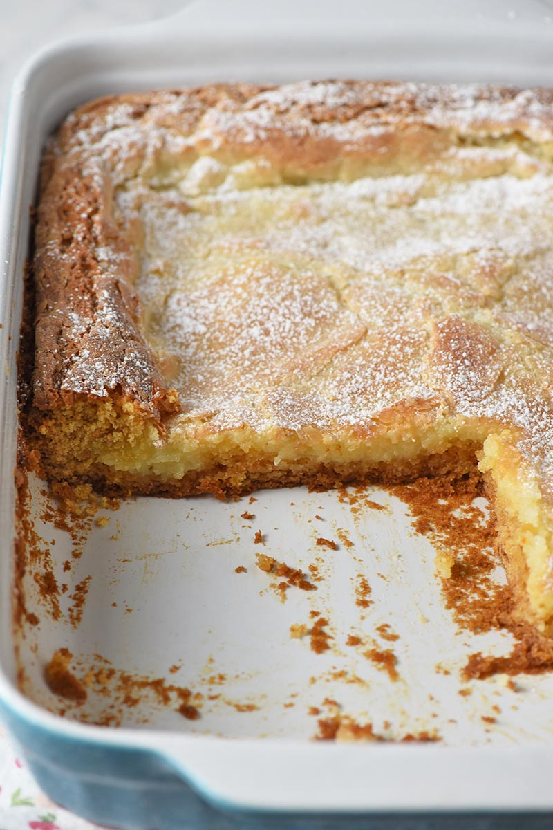 gooey butter cake made with butter cake recipe using box cake mix, sliced in baking dish