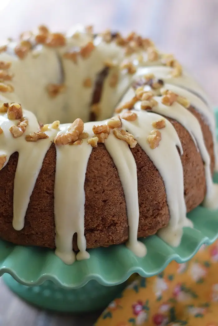 Apple Bundt Cake, made with sweet and tarty apples, cinnamon, walnuts, and a caramel cream cheese glaze. Makes a scrumptious fall and holiday dessert!
