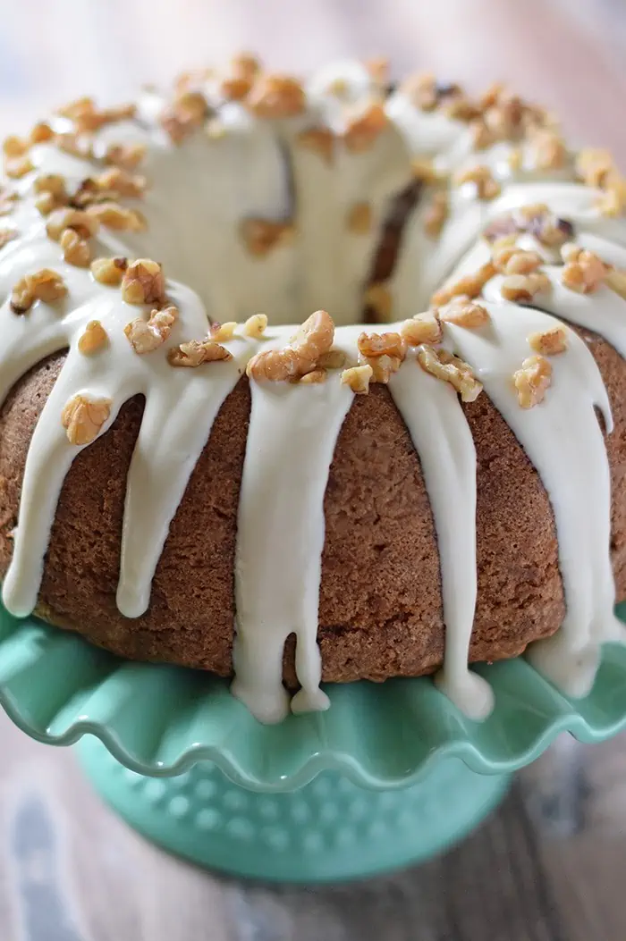 Apple Bundt Cake, a scrumptious cake recipe with apples, cinnamon, walnuts, and a caramel cream cheese glaze. Makes a delicious fall and holiday dessert!