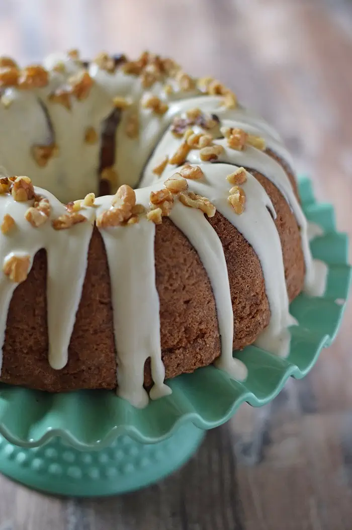 Apple Bundt Cake is a scrumptious fall dessert, made with apples, cinnamon, walnuts, and a caramel cream cheese glaze.