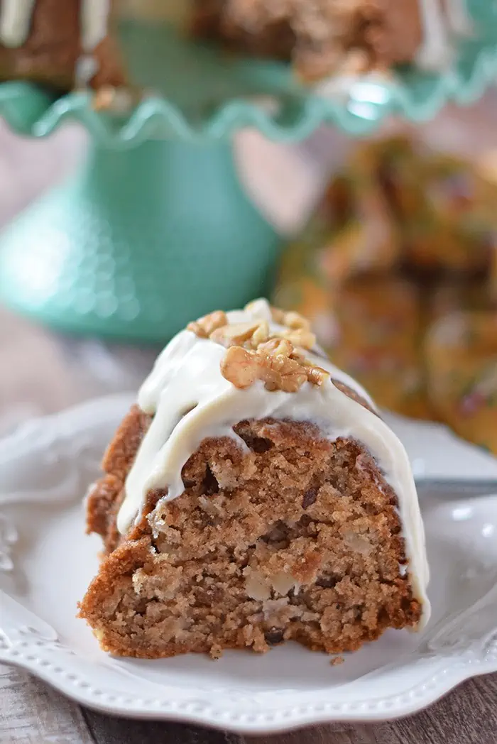 Apple Bundt Cake is a scrumptious fall and holiday dessert recipe. Make it with apples, cinnamon, walnuts, and a caramel cream cheese glaze that combines with the cake, creating an explosion of fall flavor.