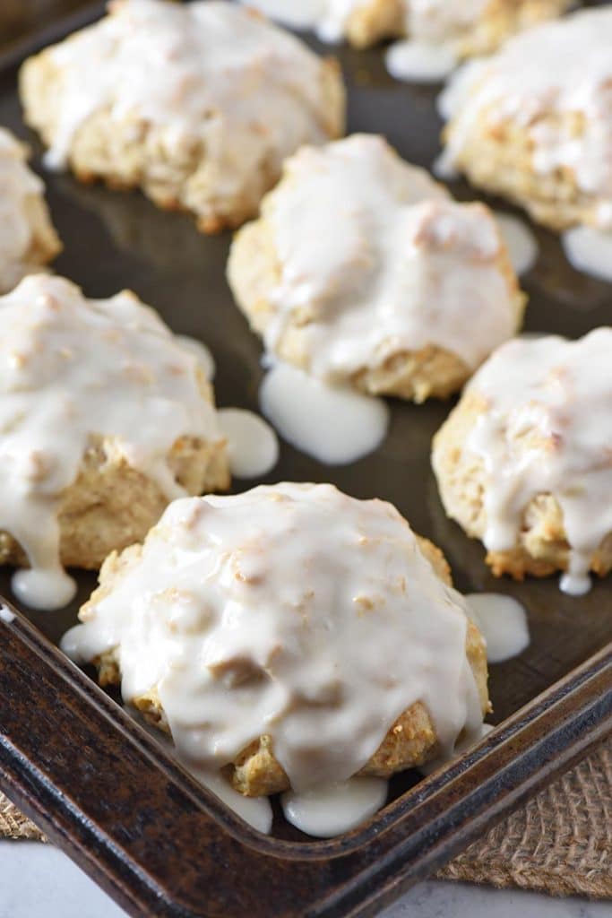 glazed Bisquick cinnamon biscuits on baking sheet