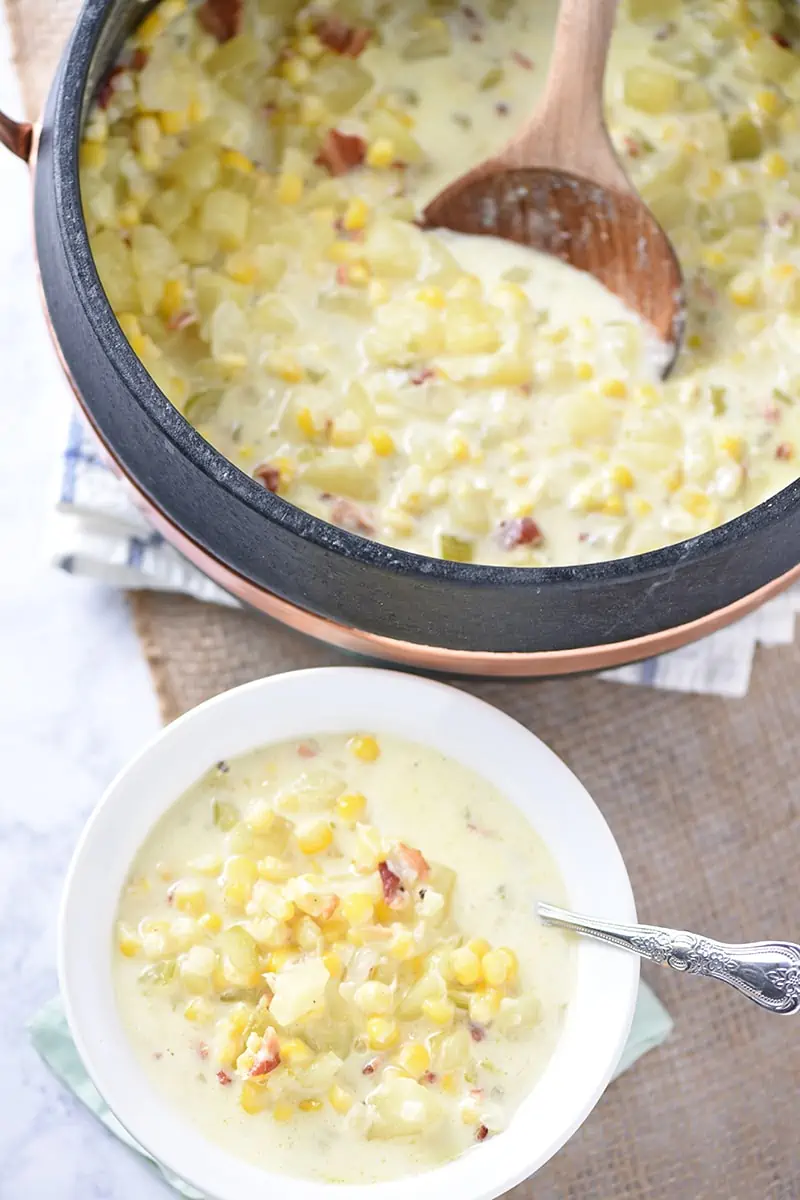 How to make hearty and delicious Creamy Potato Corn Chowder, a cozy weeknight meal filled with tasty goodness like bacon and cheddar cheese. Easy dinner idea and recipe!