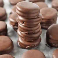 stack of chocolate covered ritz crackers with peanut butter on wax paper