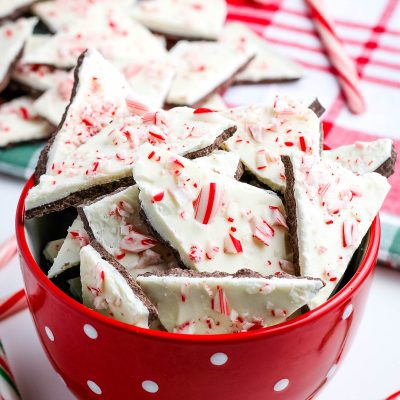 chocolate peppermint bark in red and white polka dot bowl with candy canes on white countertop