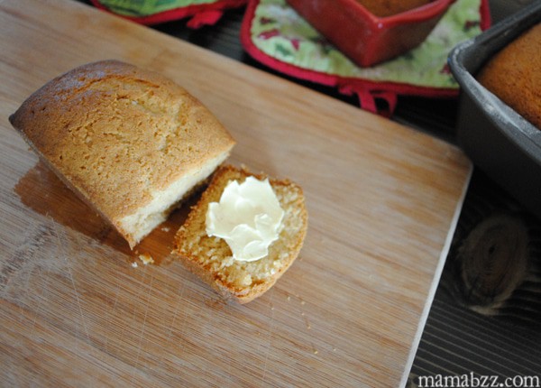 Gingerbread mini loaf sliced and served with butter sliced ginger loaf with butter on wood cutting board