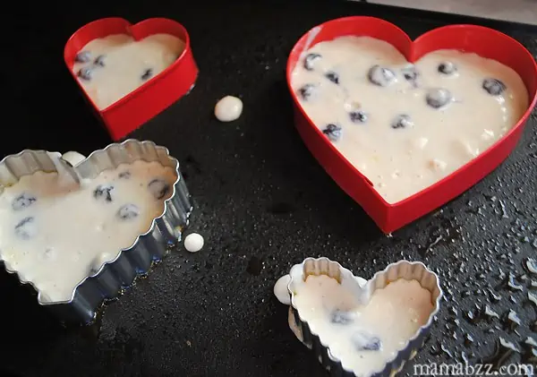 Add pancake batter to griddle, shaping with heart cookie cutters