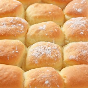 grandma's homemade yeast rolls, pillowy soft, in blue baking dish