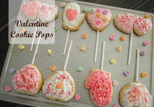 Valentine cookie pops on baking sheet