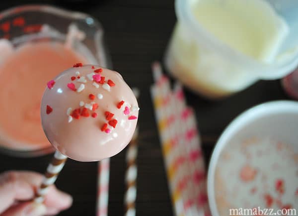 Decorate iced cake pops with Valentine sprinkles