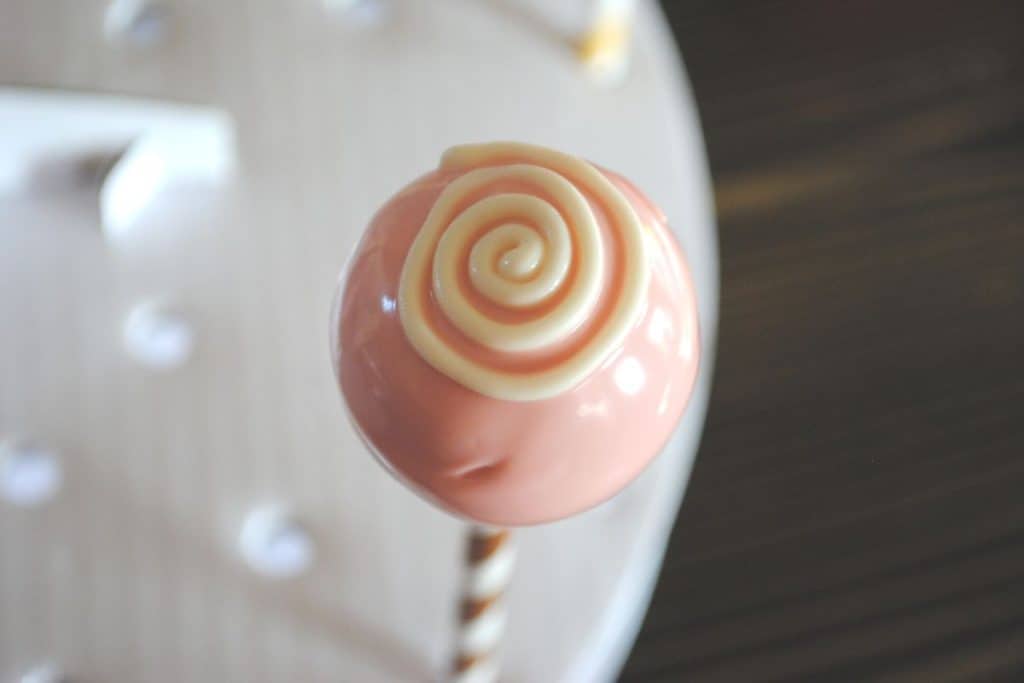 white swirl decoration on pink Valentines cake pop