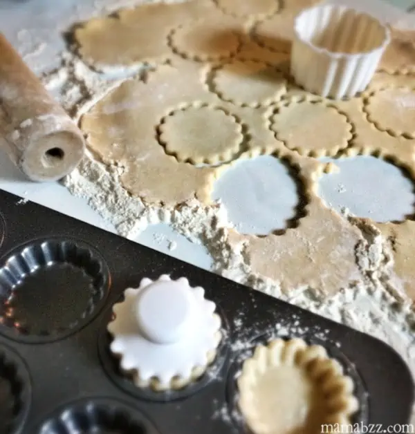 Cut dough crusts out for tarts