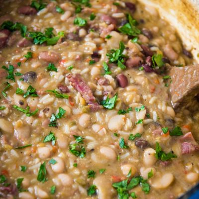 blue Dutch oven full of 15 bean soup with ham