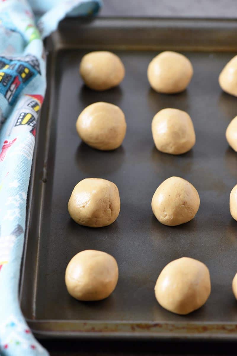 no bake peanut butter balls sitting on cookie sheet