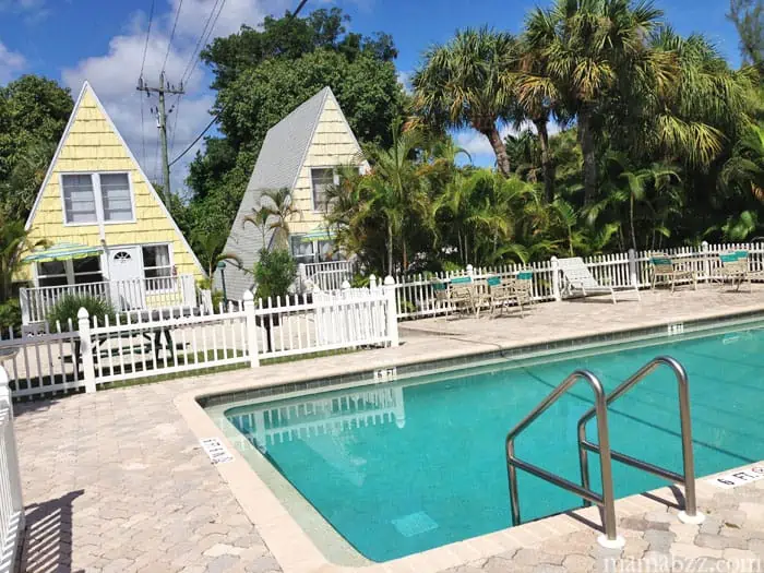 Swimming pool with cottages in background at Anchor Inn of Sanibel