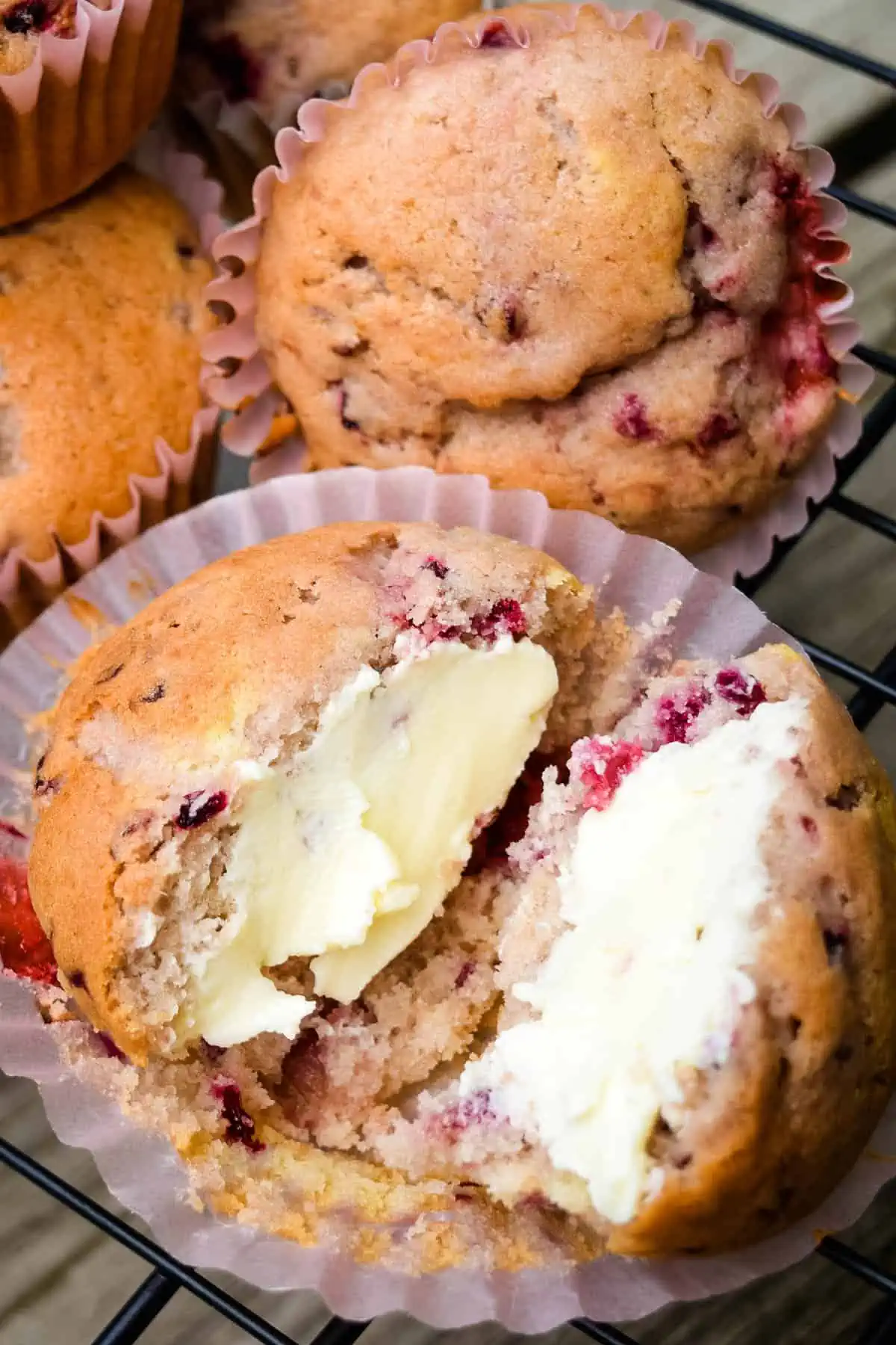 sliced and buttered strawberry blackberry muffin on cupcake liner