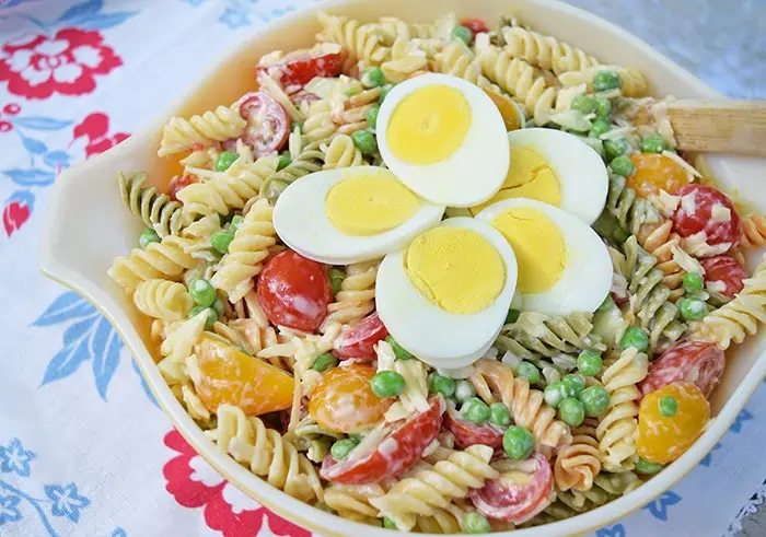 Rotini pasta coated with a lightly creamy dressing, mixed with fresh cucumbers, tomatoes, smoked cheese, and other delicious ingredients. Easy 30 minute pasta salad recipe!