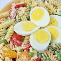 Rotini pasta coated with a lightly creamy dressing, mixed with fresh cucumbers, tomatoes, smoked cheese, and other delicious ingredients. Easy 30 minute pasta salad recipe!