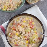 How to make a delicious White Chicken Chili in the slow cooker for an easy family meal. Filled with vegetables, white beans, chicken, green chiles, and cheese.