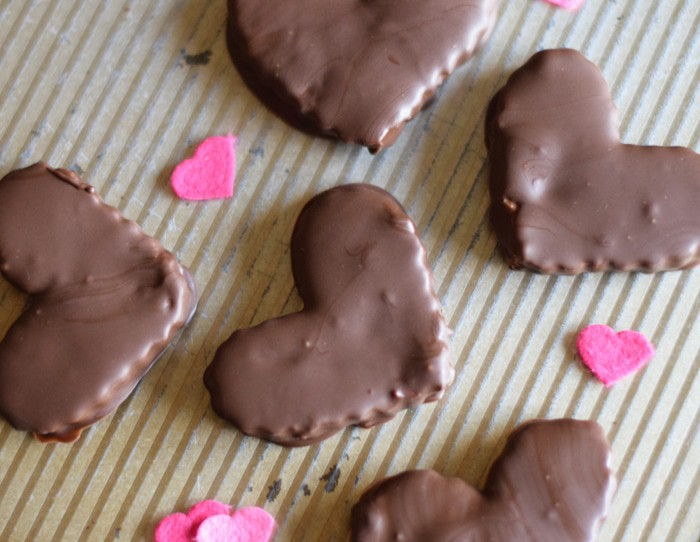 homemade Reese's hearts on baking sheet with pink hearts