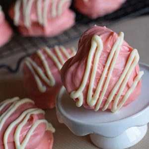 copycat Little Debbie Valentine snack cakes on wire rack and white cupcake stand