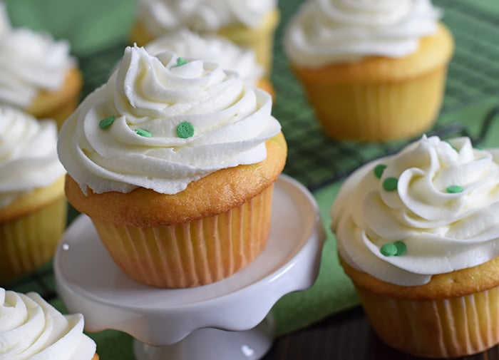 Jello cake (or poke cake) has always been one of my favorites. Learn how to make Lime Vanilla Poke Cake Cupcakes with buttercream frosting. These scrumptious cupcakes bring just a hint of green for a festive St Patricks Day or any day really.