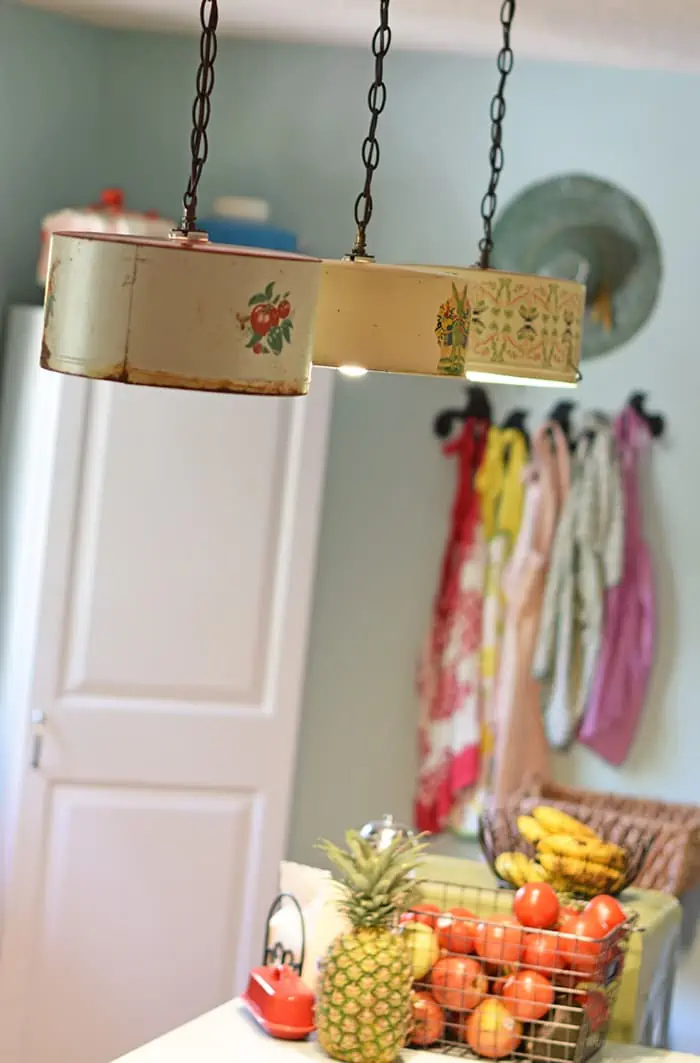 Create a farmhouse kitchen look with DIY light fixtures upcycled from vintage cake tins. How to create a charming look with affordable and simple kitchen lighting.