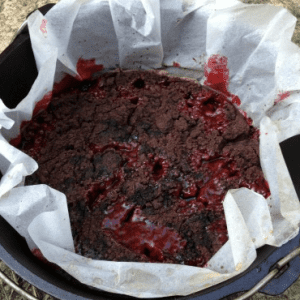 chocolate cherry campfire dump cake baked in Dutch oven