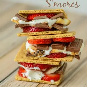 stack of chocolate covered strawberry s'mores on wooden table