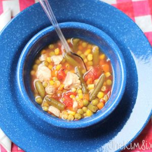 blue enamelware bowl on plate, full of Italian garden vegetable soup