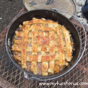 Texas peach cobbler baked in Dutch oven on campfire grate