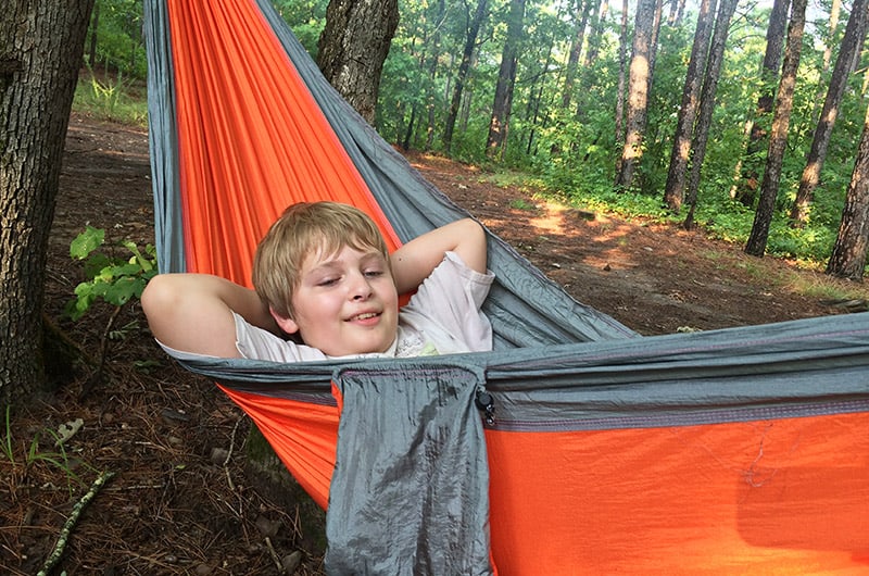 boy on orange hammock in ouachita national forest