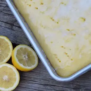 Grab the recipe for a lemon poke cake without any pudding mix. Cake mix recipe inspired by Grandma’s lemon cake. So scrumptious!