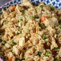 bowl of chicken fried rice with eggs and vegetables