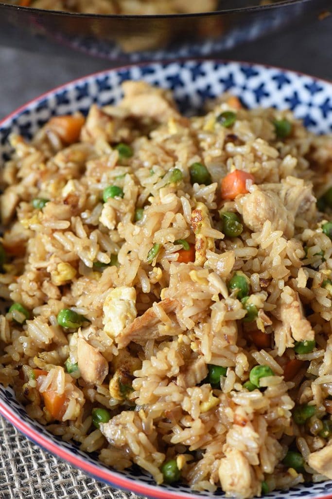bowl of chicken fried rice in a wok with eggs and vegetables