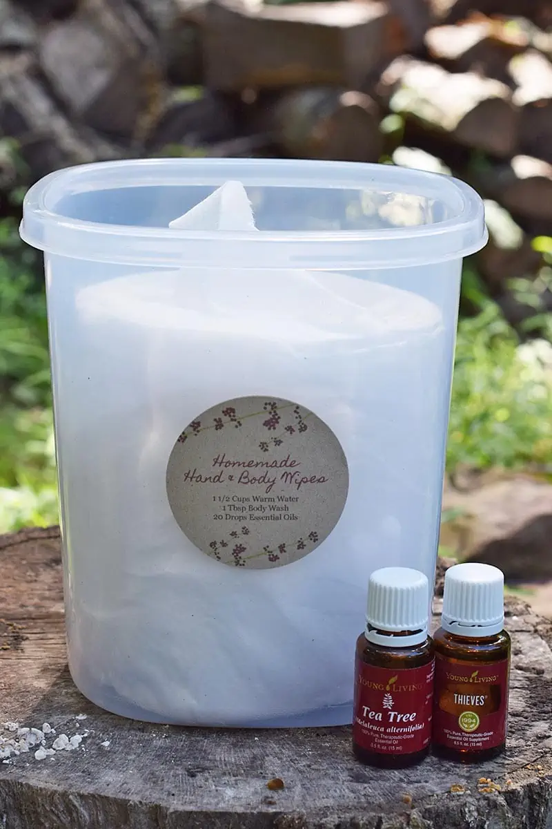 diy body wipes for camping in plastic storage container with Young Living Tea Tree Oil and Thieves Oil