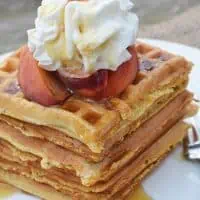 With peaches in the batter and peaches sliced on top, Peaches and Cream Waffles have a light peachy taste with a hint of cinnamon. Top them off with whipped cream and real maple syrup, and serve for a scrumptious breakfast or breakfast for dinner. Printable recipe!