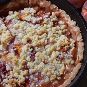 Peach cobbler is probably the easiest dessert recipe, besides chocolate chip cookies, you could ever make. Ingredients are simple, and the crust is a press-in crust, my favorite type of pie crust! Grab the recipe, bake it up in your favorite cast iron skillet (or baking dish), serve with vanilla ice cream, and watch it disappear.