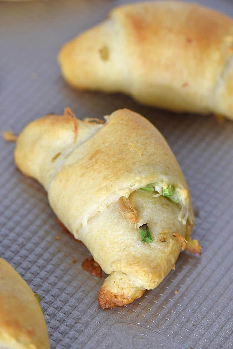 baked leftover turkey crescent rolls with green onions on a cookie sheet