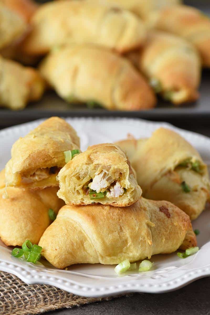 easy crescent roll appetizers with leftover turkey, cheese, and turkey stuffing on white plate with green onions