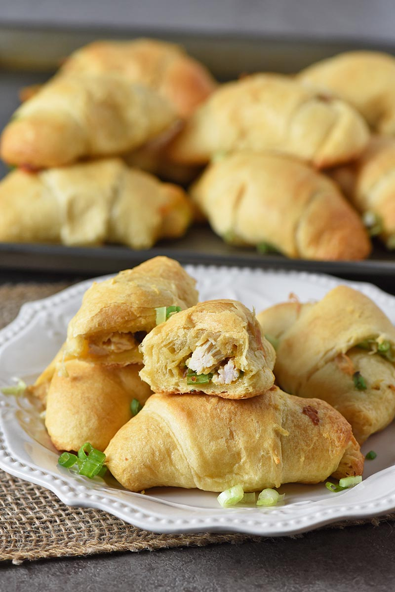 leftover turkey stuffing crescent roll appetizers on an ivory plate with cookie sheet behind