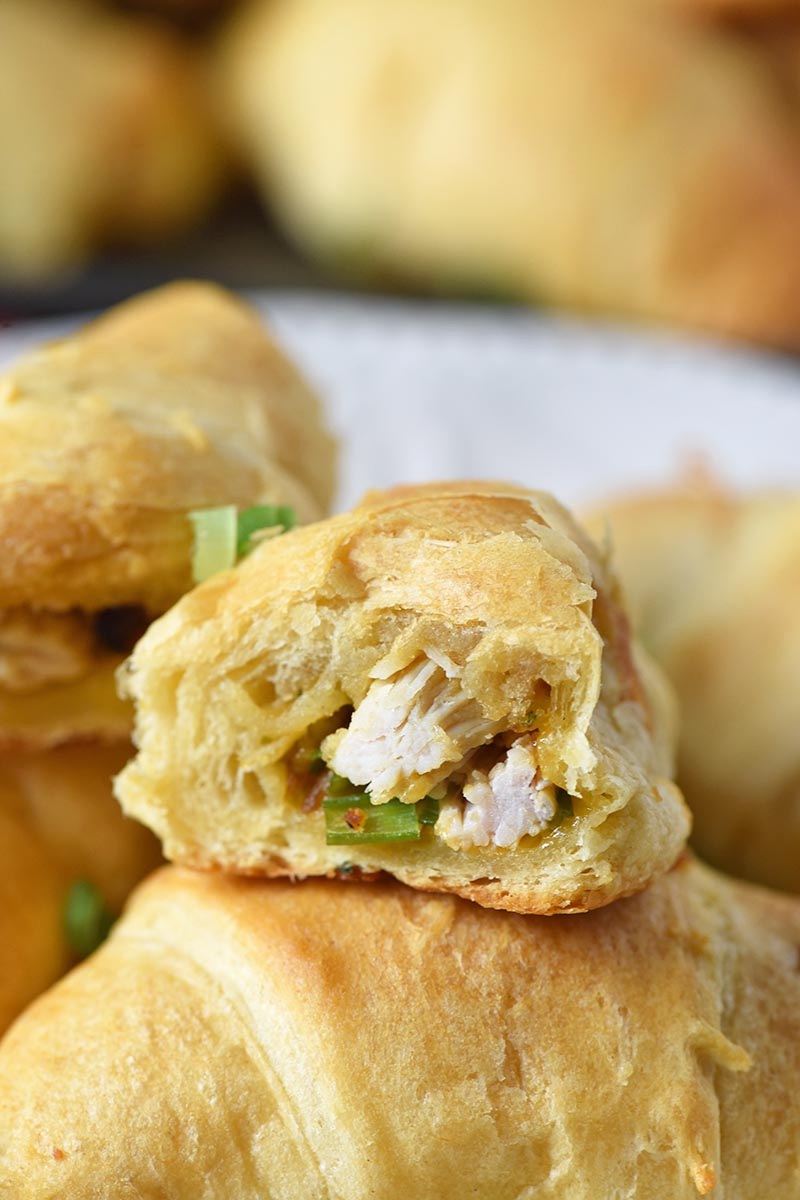 leftover turkey stuffing crescent roll sliced in half with turkey, stuffing, and green onions