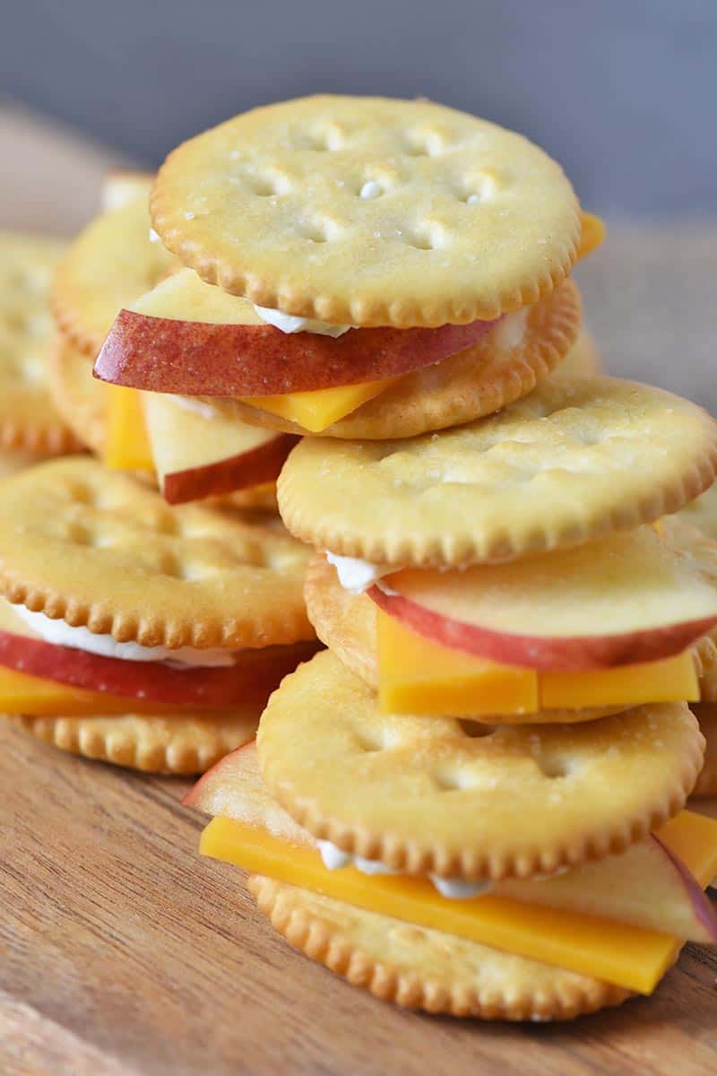 stacked apples and cheese crackers on small wooden cutting board, easy appetizer recipe