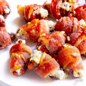 bacon wrapped dates with goat cheese on white plate