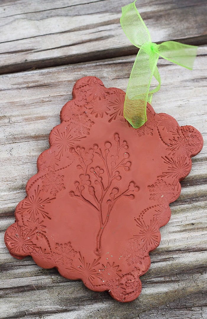 Use Air-Dry Clay, Christmas cookie cutters, and acrylic stamps to make the simplest of crafts, Clay Diffuser Ornaments. They're beautifully festive decorations for the Christmas season, and they add a touch of essential oil scents to both your tree and home.