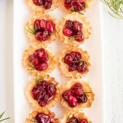 cranberry brie bites on white platter