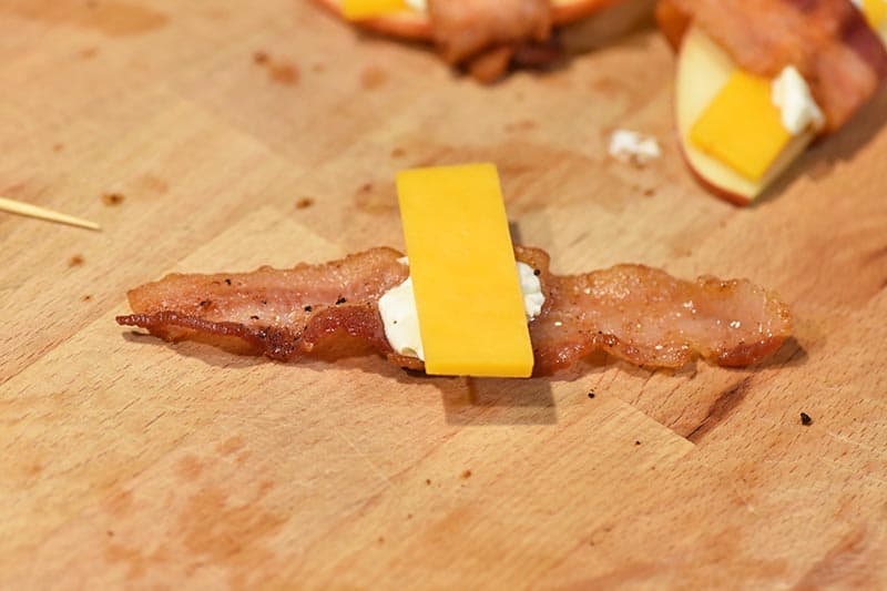 making bacon appetizers with cream cheese, apples, and cheese