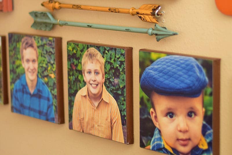 DIY canvas prints with family photos on gallery wall with metal arrows