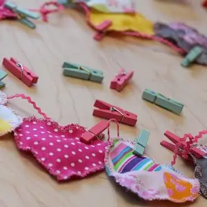 Decorate for Valentine's Day by making a super easy to sew Valentine's Day heart garland with cheap fat quarters from the fabric store. Makes the sweetest Valentine decoration and a fun craft and sewing project!