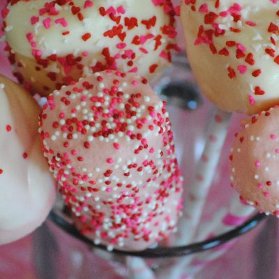Valentine marshmallow pops with sprinkles and nonpareils in glass cup